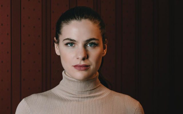 A woman wearing a turtleneck jumper.