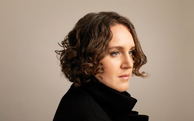 A woman in a black coat.