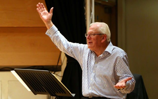 A man in a shirt conducting.
