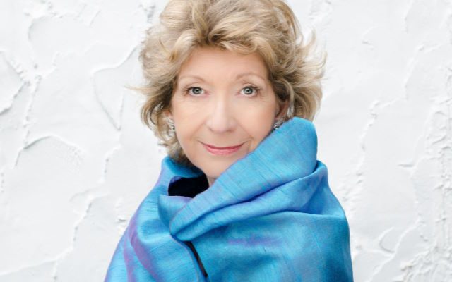 A woman ina blue shawl.