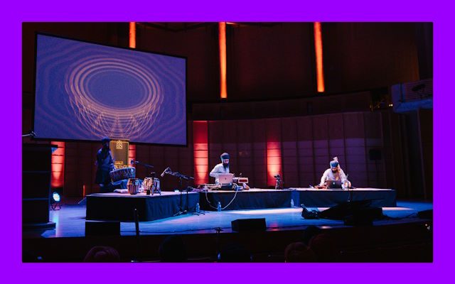Three musicians sat on the stage.