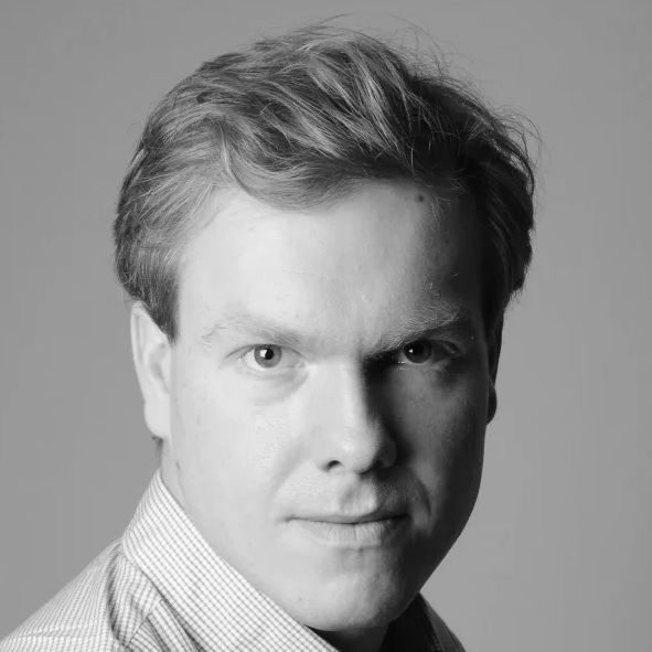 A man with short hair wearing a shirt.