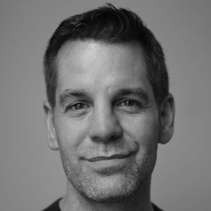 A man with a bit of stubble and short hair.