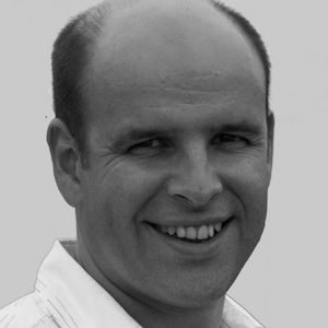 A bald man wearing a white shirt.