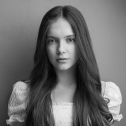 A girl with long brown hair in a dress.