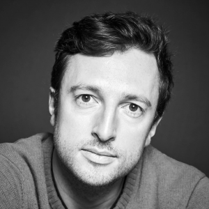 A man with dark hair wearing a jumper.