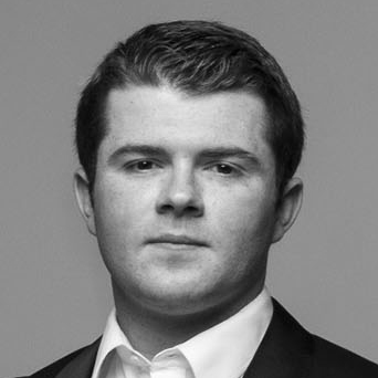 A man with short hair wearing a suit.