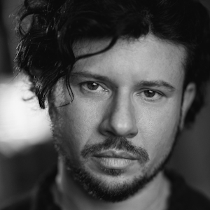 A man with long curly hair.