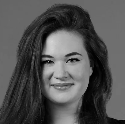 A woman with long hair and looking into the camera.