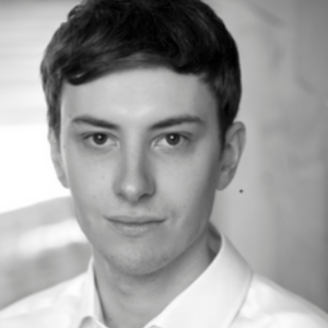 A photo of Sam Marston tenor, he is wearing a white shirt.